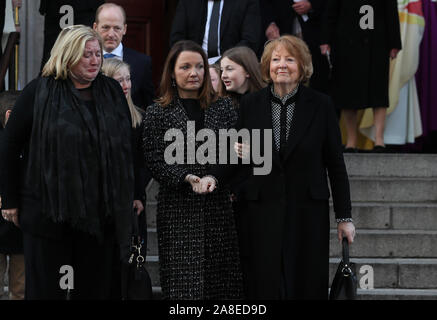 Kathleen Watkins (right), wife of the celebrated broadcaster Gay Byrne with their daughters Crona (left) and Suzy leaving St. Mary's Pro-Cathedral in Dublin following his funeral service. Stock Photo