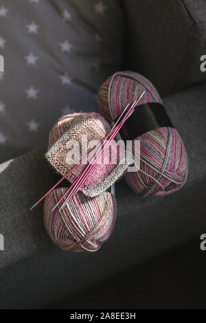 Skeins of woolen yarn and needles for hand knitting socks.  Natural colors. Concept for handmade. Stock Photo