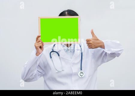 profession doctor in white coat over white isolated background with white blank board and Thumbs up. Concept of healthcare, science and medicine conce Stock Photo