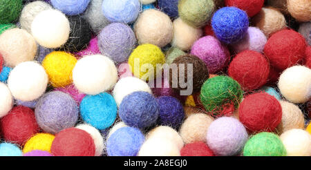 background of many felt balls for sale as decorations Stock Photo
