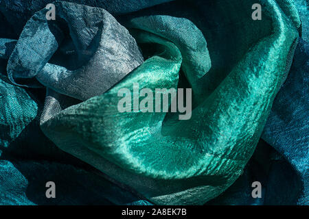 Photo of silk cloth in trendy green mint blue colors as texture holiday background. Flat lay, top view. Stock Photo