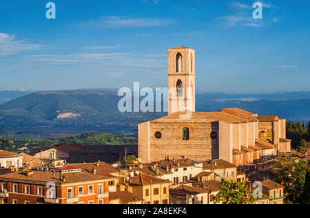 View Perugia huge and iconic St Dominic Basilica and Umbria countryside with the famous medieval city of Assisi in the background at sunset Stock Photo