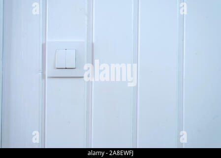 Light switch Two Switches On over a white wall Stock Photo