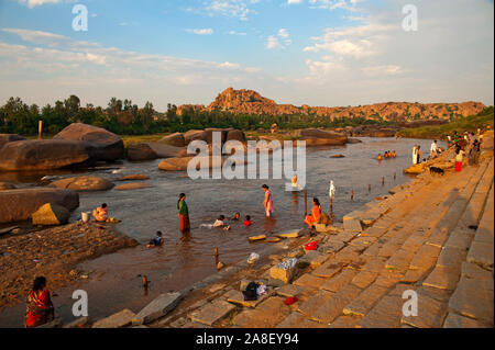 Indian people bathing at Tungabhadra river, Hampi, Karnataka, India Stock Photo