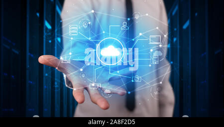 Man holding hologram projection displaying cloud technology symbols Stock Photo