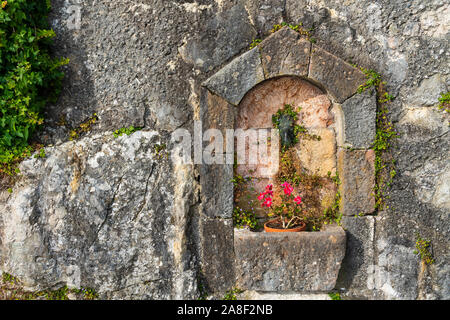 A decorative planter and stone wall in Hallstatt, Austria, Europe. Stock Photo