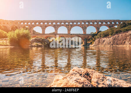 Beautiful view of the ancient Roman bridge Pont du Gard from the middle of the river Gardon Stock Photo