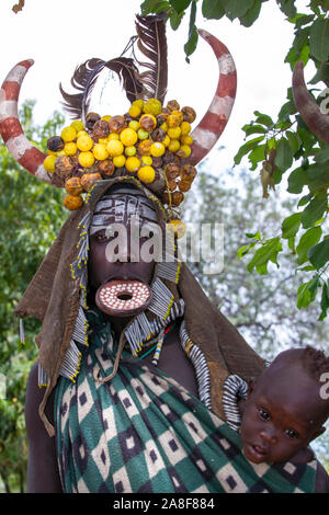 Mursi Tribe headdress woman with baby Omo Valley Ethiopia Stock Photo