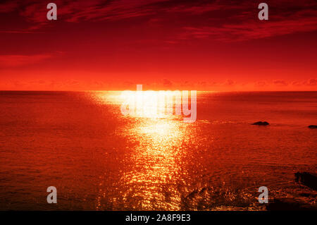 An orange and red sunset on the atlantic ocean at Ochre Point in Newport Rhode island. Stock Photo