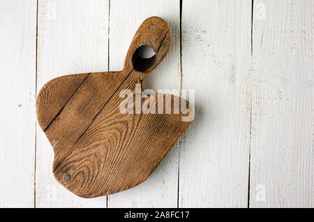 Empty wooden rustic cutting board on white background. Overhead, copy space Stock Photo