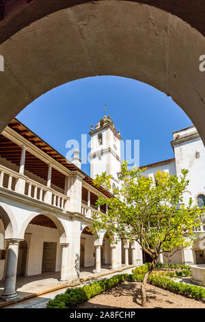 Detail of the Renaissance cloister, with roman arches, Doric columns and the bell tower in the background, of the Monastery of Saint Mary of Lorvao, C Stock Photo