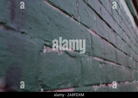 texture: old cracked brick wall painted in paint. Brick wall texture. The old wall of the building. The texture for the designer is brick with a dull Stock Photo