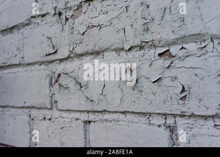 texture: old cracked brick wall painted in paint. Brick wall texture. The old wall of the building. The texture for the designer is brick with a dull Stock Photo