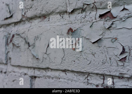 texture: old cracked brick wall painted in paint. Brick wall texture. The old wall of the building. The texture for the designer is brick with a dull Stock Photo