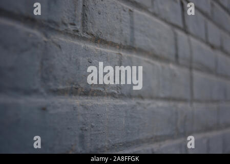 texture: old cracked brick wall painted in paint. Brick wall texture. The texture of the brick is gray. Stock Photo