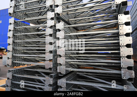 Gray big metal mobile shelving stacked in a warehouse of a construction shopping center. Shelves for placement and storage of goods in building Stock Photo