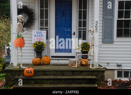 Skeleton marriage proposal on front porch in front yard, Yarmouth Maine, USA Stock Photo