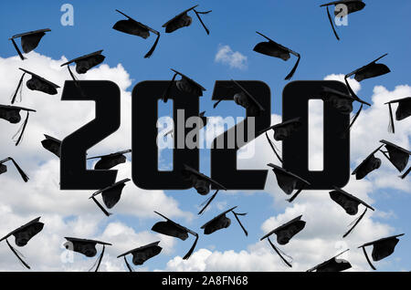 airborne black graduation caps in summer sky for class of 2020 Stock Photo