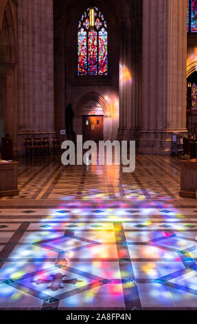 Washington, DC - 4 November 2019: Sunbeams from the stained glass windows of National Cathedral in Washington DC Stock Photo