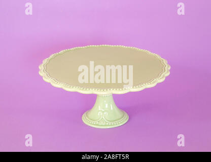 Green vintage cakestand on purple background Stock Photo
