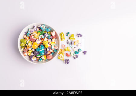 Colored Popcorn candy isolated on white background, soft light, studio shot, copy space. Junk food, fruit flavored popcorn. Colorful, multicolor, cand Stock Photo