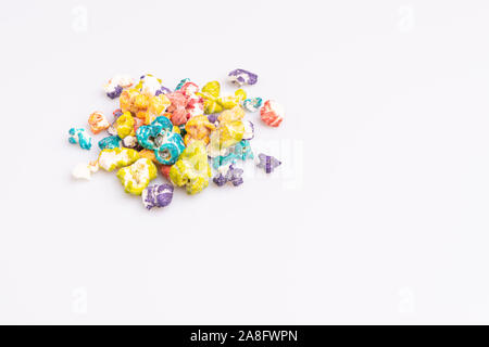 Colored Popcorn candy isolated on white background, soft light, studio shot, copy space. Junk food, fruit flavored popcorn. Colorful, multicolor, cand Stock Photo