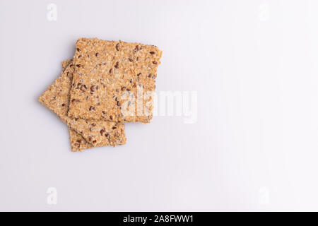 Diet flax seed whole grain crackers isolated on white background, soft light, copy space Stock Photo
