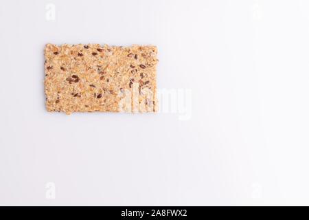 Diet flax seed whole grain crackers isolated on white background, soft light, copy space Stock Photo