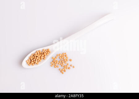 Yellow mustard seeds isolated on white background, soft light, studio shot, copy space. Latin name 'Brassica hirta'. Stock Photo