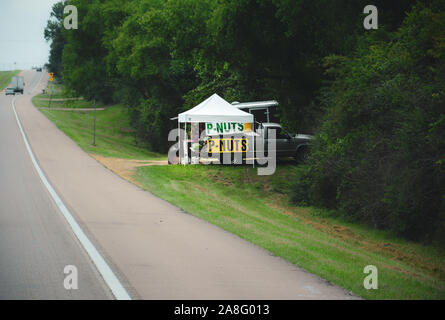 A pick up truck tailgate and tent shade the P-Nuts and watermelons for sell at a roadside fruit stand in Southern Mississippi, USA Stock Photo