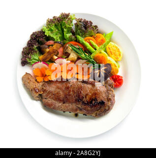 Beef steak with black peppers decorate fresh rosemary, asparagus grilled oyster mushroom and radish salad carved vegetables style top view Stock Photo