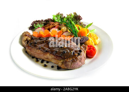 Beef steak with black peppers sauce decorate fresh rosemary, broccoli grilled oyster mushroom and radish salad  carved vegetables style side view Stock Photo