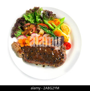Beef steak with black peppers sauce decorate fresh rosemary, broccoli grilled oyster mushroom and radish salad  carved vegetables style top view Stock Photo