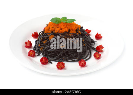 Black Spaghetti stir fried with tobiko egg by flying fish original tasty cooking dish fusion style Japanese and Italian mixed decorate with carved tom Stock Photo