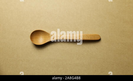 Wooden spoon on brown background Stock Photo