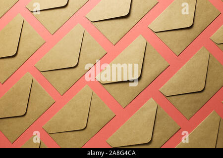 Kraft brown paper envelopes on pink background Stock Photo