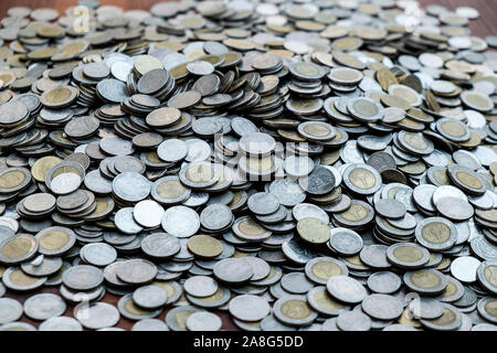 Lots coin on wooden desk with blurred background texture, Investment and saving concept, Money stack for business planning investment, A lot of money Stock Photo