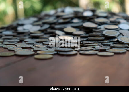 Lots coin on wooden desk with blurred background texture, Investment and saving concept, Money stack for business planning investment, A lot of money Stock Photo