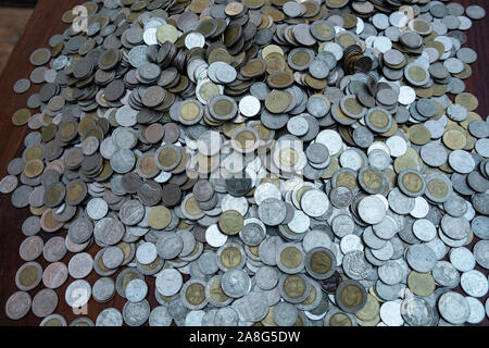Lots coin on wooden desk with blurred background texture, Investment and saving concept, Money stack for business planning investment, A lot of money Stock Photo