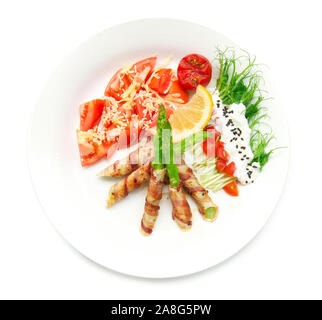 Bacon wrapped asparagus grilled with pea sprouts roll  salad on top greek yogurt sprinkle black sasemi and tomato salad on top chedda cheese decorate Stock Photo