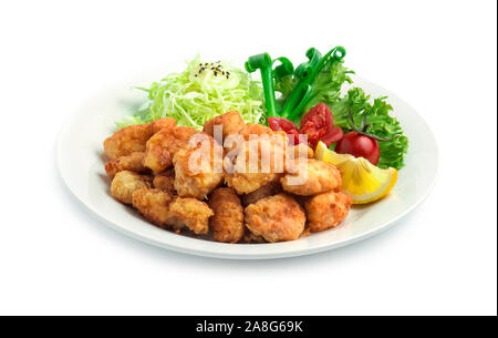 Karaage Fried Chicken Japanese food fusion style with mayonage sauce on slice cabbage decorate spring onion,tomato, lemon, vegetables side view Stock Photo