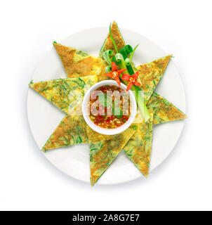 Fried Eggs with Climbing Wattle Triangles shape (Acasia Pennata Omelette) Thai food style inside dish with decorate carved vegetables, chili peppers, Stock Photo