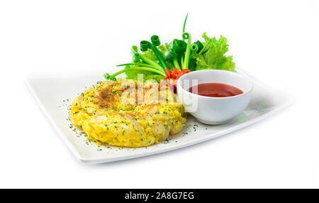 Omelette fried eggs pancake fusion Thai food style inside dish decorate with carved vegetables, chili peppers, spring onion with chili sauce dipping s Stock Photo