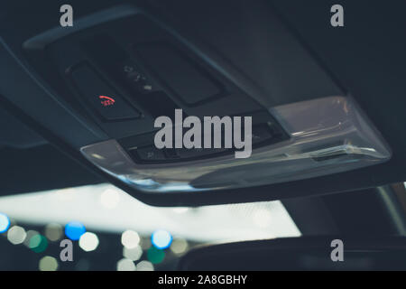 Car ceiling lamp and switch turn on-off in car,swich sos phone in car Stock Photo