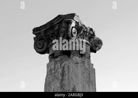 Ancient roman greek column with broken chapiter. Pompeii, Italy. Black and white photo Stock Photo