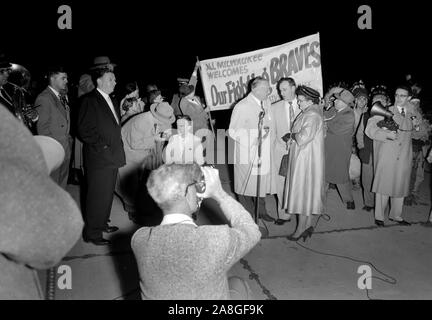 A crowd of men watches the 1958 World Series between the New York Yankees  and the Milwaukee Braves on televisions set up during the lunch hour in a  plaza along the Chicago