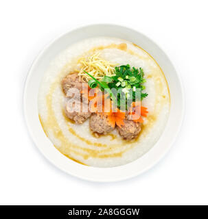 Congee Pork ,Rice Porridge served slice ginger and cutlet Celery,coriander thai herb. Asian Food breakfast decorate with carved carrots and spring oni Stock Photo