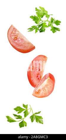 floating parsley and tomatoes isolated on white background Stock Photo