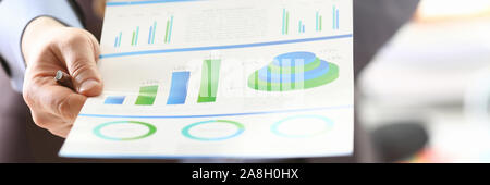 Person Analyzing Business Proceeds Using Graph Stock Photo