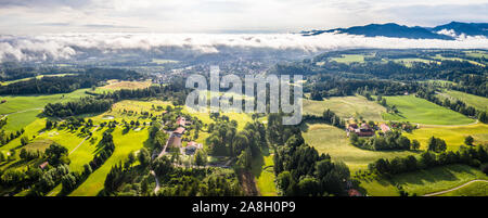 Aerial Bad Toelz Bavarian Alps. Golf Course. Blomberg Mountain. Morning Drone Shot with some clouds in the sky Stock Photo